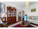 Inviting living room featuring a china cabinet, hardwood floors, and stylish decorations at 2723 Forestdale St, St Cloud, FL 34771