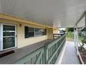 Inviting covered porch with green railing, and a welcoming door at 2808 Drake Dr, Orlando, FL 32810