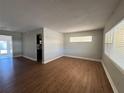 Spacious living room with light gray walls and wood-look laminate flooring at 2808 Drake Dr, Orlando, FL 32810