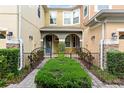 Inviting front porch with an arched entryway, manicured bushes, and decorative iron gates at 2829 Shady Willow Ln, Oviedo, FL 32765