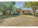 Charming single-story home featuring manicured landscaping and a welcoming walkway at 289 N Wilderness Pt, Casselberry, FL 32707