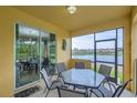 Covered patio with dining table, chairs, and view of the lake from sliding glass doors at 2999 Buccaneer Palm Rd, Kissimmee, FL 34747
