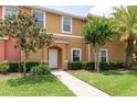 This beautiful townhouse offers a tile roof, green grass, and well-maintained shrubs at 3069 White Orchid Rd, Kissimmee, FL 34747