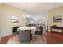 Elegant dining room with a marble table and chairs, hardwood floors, and neutral color scheme at 3198 Abana Path, The Villages, FL 32163