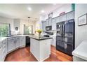 Modern kitchen features stainless steel appliances, granite countertops, and a center island at 3380 Pawleys N Loop, St Cloud, FL 34769