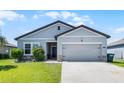 Charming single-Gathering home with well-manicured lawn and an attached two-car garage at 3519 Fernanda Dr, Deltona, FL 32738