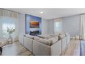 Stylish living room featuring a cozy fireplace, large sectional sofa, and lots of natural light at 3519 Fernanda Dr, Deltona, FL 32738