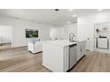 Modern kitchen featuring a central island, stainless steel appliances and wood flooring at 3981 Great Smokey Way, Apopka, FL 32712