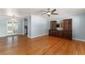 Open living area featuring beautiful wood floors, a ceiling fan, and a built-in cabinet at 439 Sunrise Ct, Orlando, FL 32803