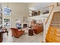 Spacious living room with a fireplace, high ceilings and open staircase to a second-floor at 518 Glen Grove Ln, Orlando, FL 32839