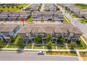 Aerial view of modern townhomes boasts manicured lawns and a well-planned community layout at 6132 Bimini Twist Loop, Orlando, FL 32819