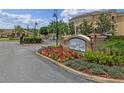 Welcoming entrance sign surrounded by colorful flowers enhances the community's curb appeal at 621 Terrace Ridge Cir # 621, Davenport, FL 33896