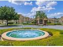 Community clubhouse and fountain create a serene and inviting atmosphere for residents at 621 Terrace Ridge Cir # 621, Davenport, FL 33896