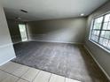 Bright living area features neutral tones and a mix of tiled and carpet flooring at 6624 Kristin Ct, Orlando, FL 32818