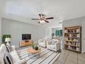 Inviting living room featuring tile floors, ceiling fan, and modern furnishings at 7614 Sw 80Th St, Ocala, FL 34476