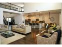 Open-concept living room with a modern kitchen, dark wood floors, and lots of seating at 9005 Reflection Pointe Dr, Windermere, FL 34786