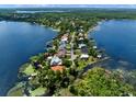 Breathtaking aerial view of a waterfront community, showcasing luxurious homes surrounded by sparkling lakes and lush greenery at 9916 Lone Tree Ln, Orlando, FL 32836