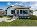 Inviting home exterior showcasing a covered porch with updated railing and tidy landscaping at 1040 20Th St, Orlando, FL 32805