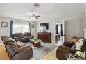Spacious living room with tile floors, comfortable seating, and a view into the bedroom at 10934 Tangora St, Orlando, FL 32825
