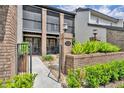 Eye-level angle showcasing the brick facade of a townhouse, emphasizing its landscaped entrance at 1130 Washington Ave # 11, Winter Park, FL 32789