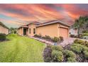 Beautiful single-story home with well-maintained lawn, brick driveway, and lovely front yard landscaping at 145 Palazzo Ln, Kissimmee, FL 34759
