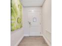 Inviting hallway with wood floors and modern artwork at 14501 Grove Resort Ave # 2438, Winter Garden, FL 34787