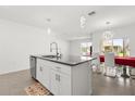 Kitchen island featuring granite countertops, double sinks, a dishwasher and stylish pendant lighting at 1693 Barberry Dr, Kissimmee, FL 34744