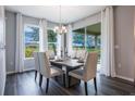 Elegant dining room with a large window, sliding glass door, and modern light fixture at 1977 Walnut Creek Dr, Kissimmee, FL 34744