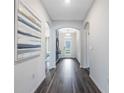 Bright hallway with wood floors, archways, and a view of the front door at 1977 Walnut Creek Dr, Kissimmee, FL 34744