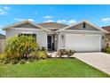 Charming single-Gathering home with a well-manicured lawn and a two-car garage in a suburban neighborhood at 208 Summerlin Ln, Haines City, FL 33844