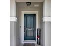Close-up of an inviting front door with a decorative 'Welcome' sign and elegant door hardware at 208 Summerlin Ln, Haines City, FL 33844