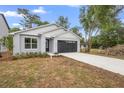 Well-maintained single-Gathering home featuring a two-car garage, manicured landscaping, and a modern design at 2131 Brighton Ln, Orlando, FL 32817