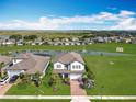 Stunning aerial view of home, lake, and community at 2312 Panoramic Cir, Apopka, FL 32703