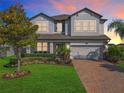 Beautiful two-story home with brick driveway and lush landscaping at 2312 Panoramic Cir, Apopka, FL 32703