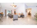 Bright and airy living room with vaulted ceilings, neutral walls, tile flooring, and contemporary furnishings at 237 Church St, Lake Helen, FL 32744