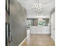 Bright foyer featuring hardwood flooring, modern light fixtures, and an open view into the adjacent living spaces at 2756 Summerfield Rd, Winter Park, FL 32792