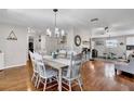 Open-concept dining room with hardwood floors, views into the living area and decor at 2859 T C U Blvd, Orlando, FL 32817