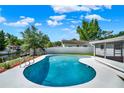 Backyard pool with updated pool deck, lush landscaping and canal view at 2859 T C U Blvd, Orlando, FL 32817
