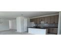 Open concept kitchen with black countertops, stylish cabinets, and modern fixtures at 30155 Rustic Mill Street, Mount Dora, FL 32757