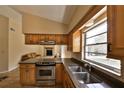 Bright kitchen with stainless steel appliances, granite countertops, and views into the living room at 309 Panama Cir, Winter Springs, FL 32708
