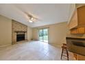 Inviting living room featuring a brick fireplace, tile flooring, and sliding glass doors to backyard at 309 Panama Cir, Winter Springs, FL 32708