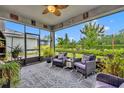 Inviting screened-in patio with comfortable seating, neutral colors, and views of the serene backyard at 3149 Songbird Cir, Harmony, FL 34773