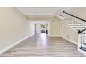 Bright living room features modern flooring, staircase with black and white trim, and sliding glass doors to the outside at 315 Glenview Blvd # 3, Daytona Beach, FL 32118