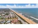 Breathtaking aerial view of beachfront properties along the scenic coastline, highlighting the property's prime location at 3180 Ocean Shore Blvd # 407, Ormond Beach, FL 32176