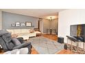 Comfortable living room with a plush white couch, modern area rug, and neutral tones providing a cozy atmosphere at 320 Lakeview St # 208, Orlando, FL 32804