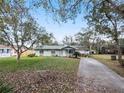 Quaint single-story home with mature trees in a tranquil neighborhood setting at 35724 Dawn Dr, Leesburg, FL 34788