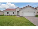 Charming single-story home featuring a two-car garage, well-manicured lawn, and a welcoming front entrance at 459 Cinnamon Dr, Kissimmee, FL 34759