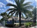 Community entrance featuring the Huntley Park sign, lush landscaping, and a decorative wrought iron fence at 4652 Oak Arbor Cir, Orlando, FL 32808