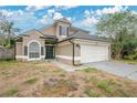 Two-story home featuring neutral paint, a two-car garage, arched windows, and a well-maintained roof in a suburban setting at 468 Wexdon Ct, Lake Mary, FL 32746