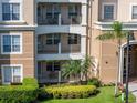 View of the condo exterior featuring balconies and well-maintained landscaping at 4816 Cayview Ave # 20111, Orlando, FL 32819